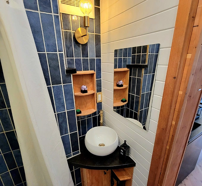 Bathroom with Blue Tile and Wood Finishes