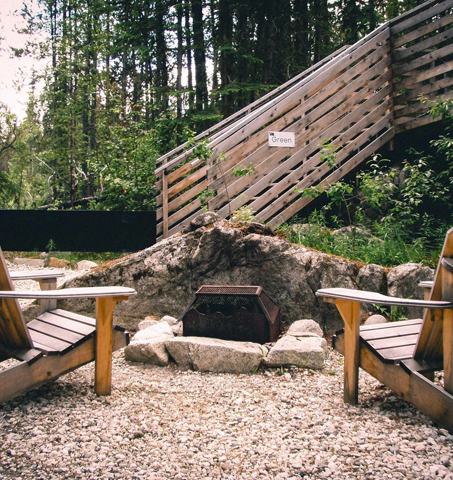 Fire Pit Beside a Forest Cabin